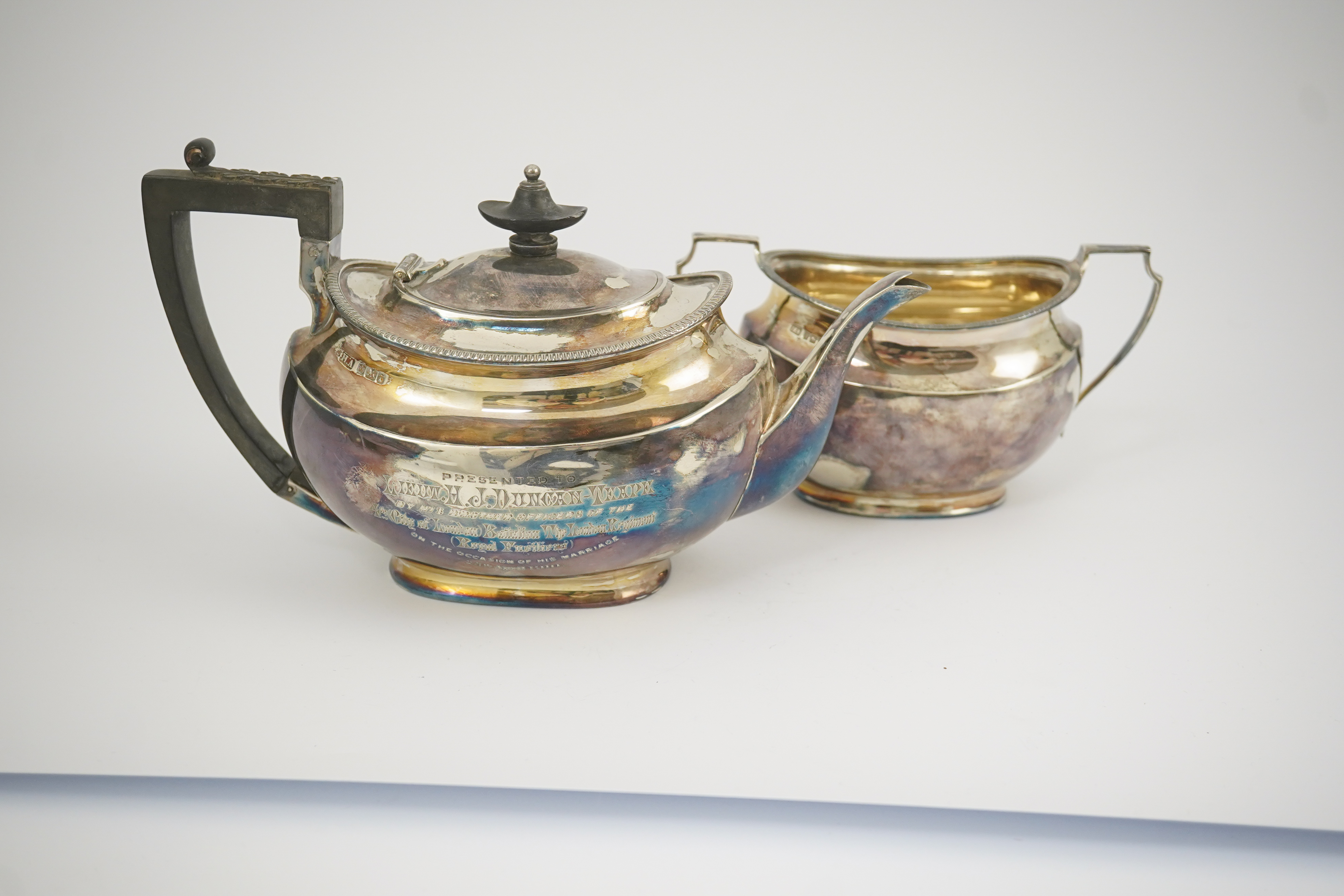 An Edwardian silver teapot and a matching sugar bowl, with engraved inscription, relating to the Royal Fusiliers, by Atkin Brothers